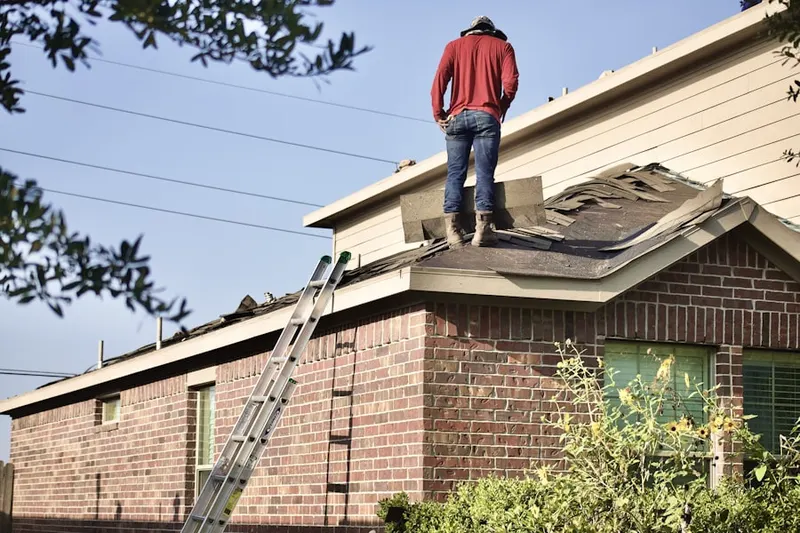 Professional roofer working on a residential roof in New Baltimore
